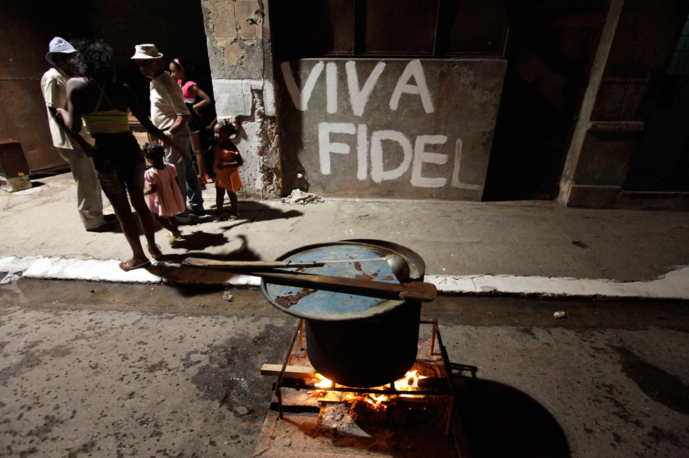 Cubans share a drink and some food while celebrating the 50th anniversary of the Committees for the Defense of the Revolution (CDR) in Old Havana
